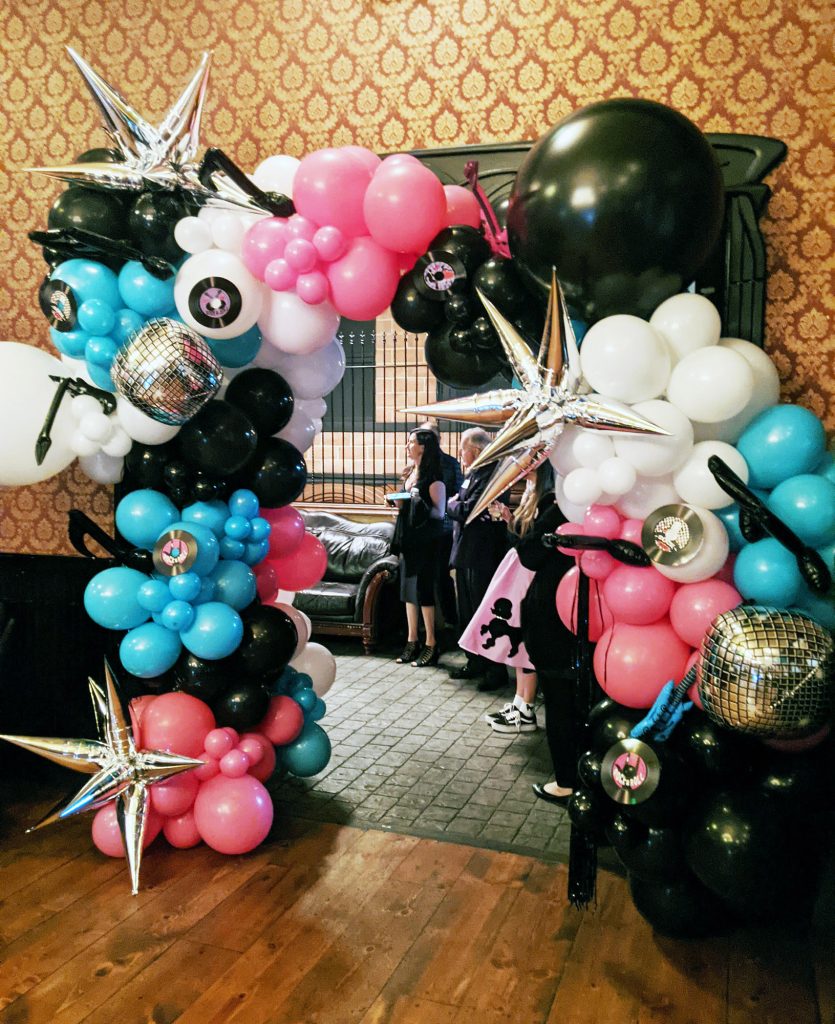 A beautiful blue black and pink balloon arch by Zepplin Balloons