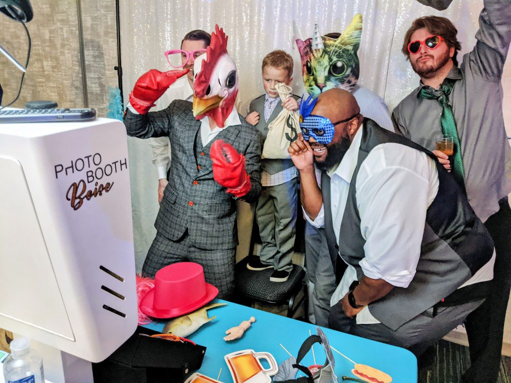 A group of groomsmen getting their photo taken at the photo booth