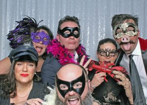Bat man joins the photo of this fun group of people all dress up for the party