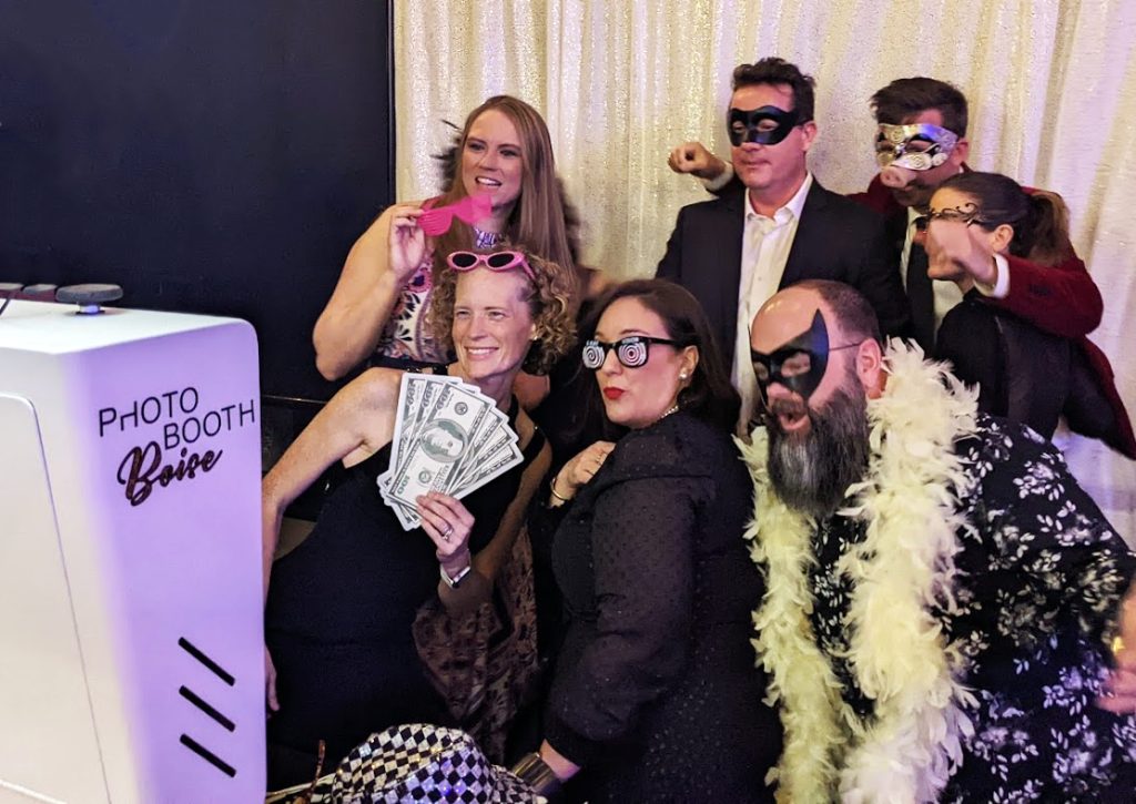 The money shot - a group takes a photo with money themed props in the photo booth