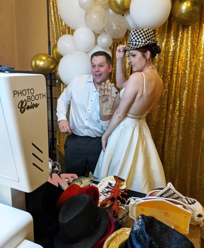 Bride and groom with fun photo booth props