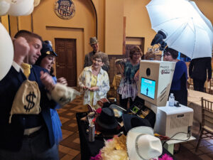 A shot of people using the photo booth and the fun props.
