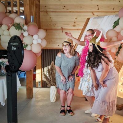 3 women standing in front of Photo Booth Boise's Social Booth with a customer 40 backdrop